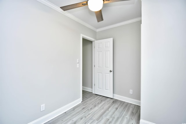 unfurnished room with ceiling fan, light wood-type flooring, and ornamental molding