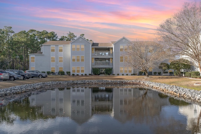 outdoor building at dusk featuring a water view