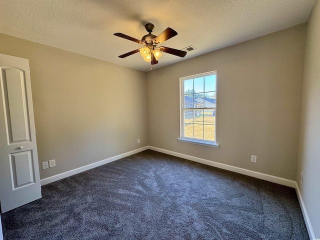 carpeted spare room with a textured ceiling and ceiling fan