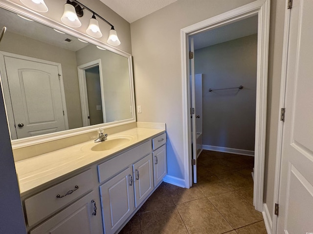 bathroom with tile patterned floors and vanity