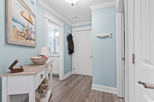 interior space with light wood-type flooring and crown molding