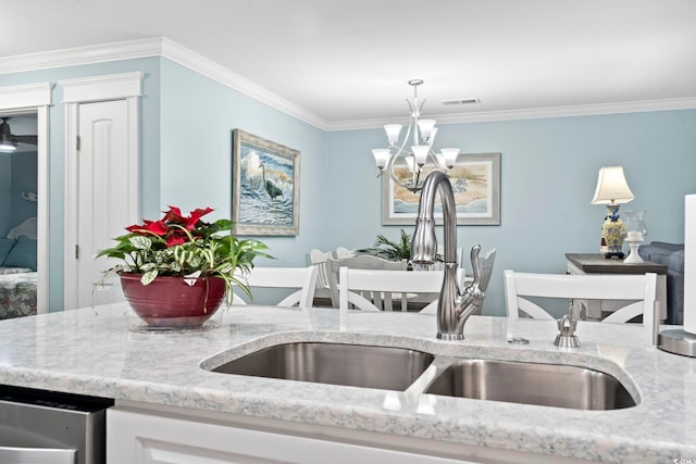 kitchen featuring white cabinets, sink, crown molding, and pendant lighting