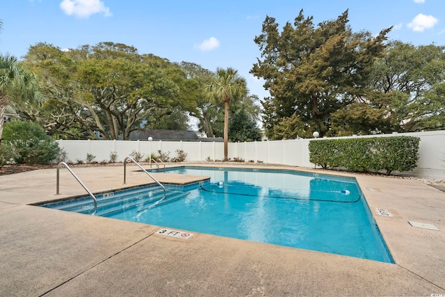 view of swimming pool featuring a patio area