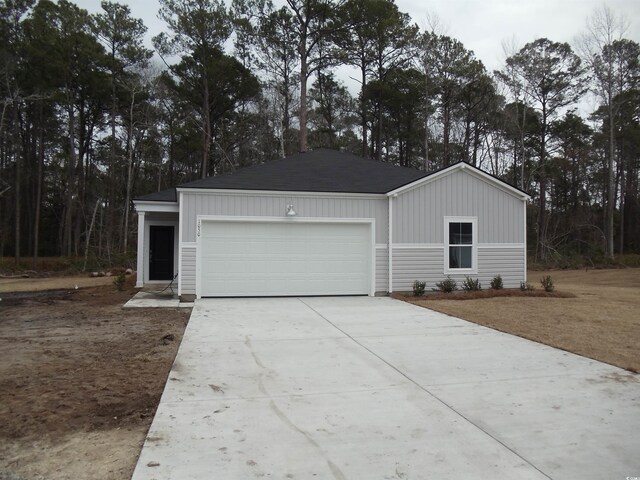 view of front facade with a front yard and a garage