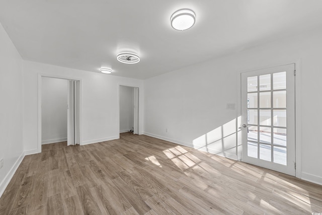 spare room with light wood-style flooring and baseboards