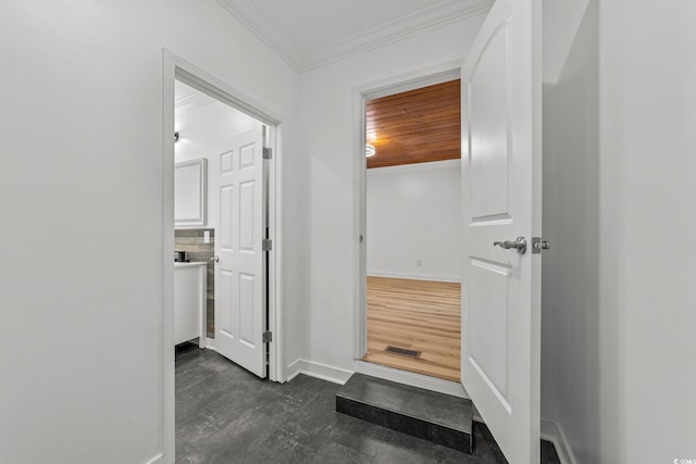 interior space with ornamental molding, wooden ceiling, and baseboards