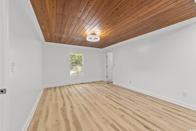 empty room featuring wood ceiling, light wood-style flooring, and baseboards