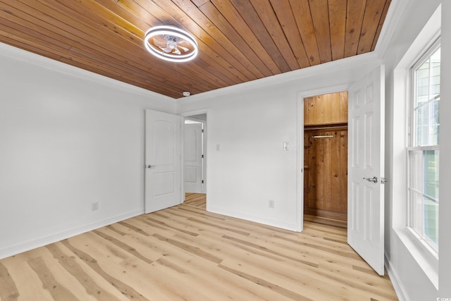 unfurnished bedroom with wooden ceiling, baseboards, light wood-style floors, and crown molding