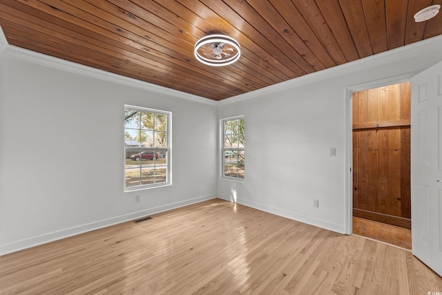 spare room featuring wooden ceiling, visible vents, baseboards, ornamental molding, and light wood-type flooring