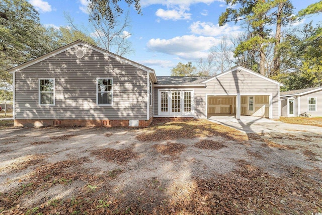 back of property with crawl space and concrete driveway