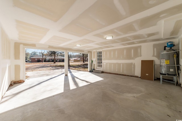 interior space featuring unfinished concrete flooring and secured water heater