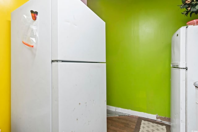 kitchen featuring hardwood / wood-style flooring and white fridge