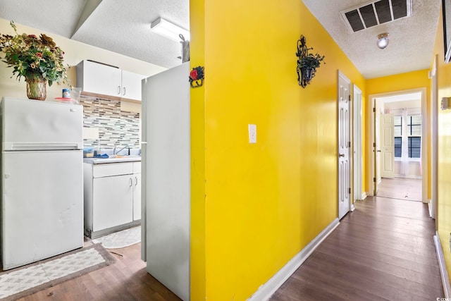 815 Rogers Dr, Myrtle Beach, SC 29577 - hallway featuring a textured ceiling and dark wood-style flooring