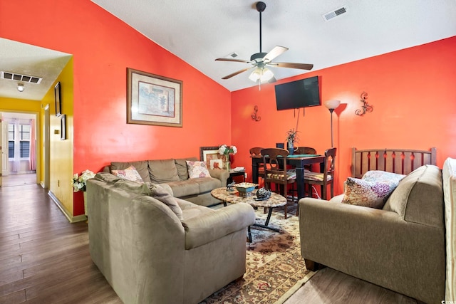 living room with hardwood / wood-style flooring, vaulted ceiling, and ceiling fan