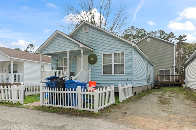 815 Rogers Dr, Myrtle Beach, SC 29577 - shotgun-style home with a porch and a fenced front yard