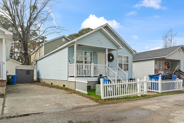 view of front of house with a porch and a shed