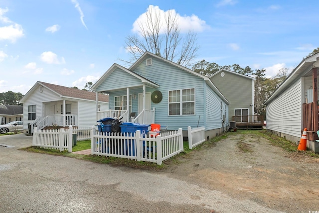 815 Rogers Dr, Myrtle Beach, SC 29577 - shotgun-style home featuring a porch and a fenced front yard