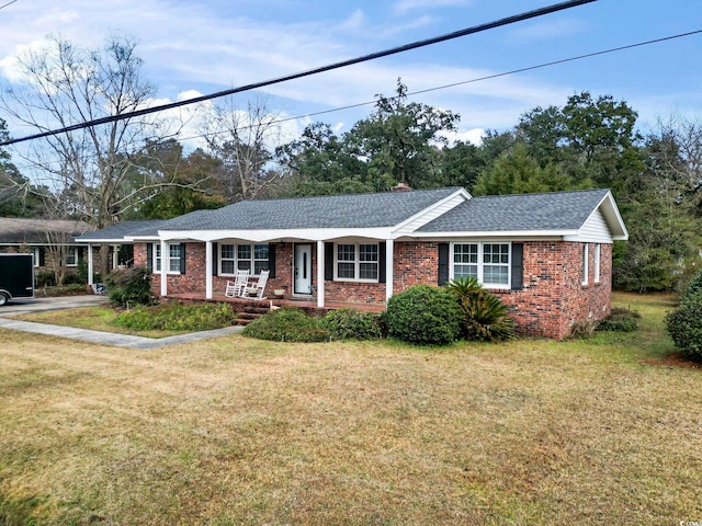 ranch-style home featuring a porch and a front yard