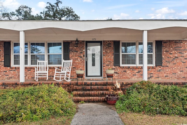 doorway to property featuring covered porch