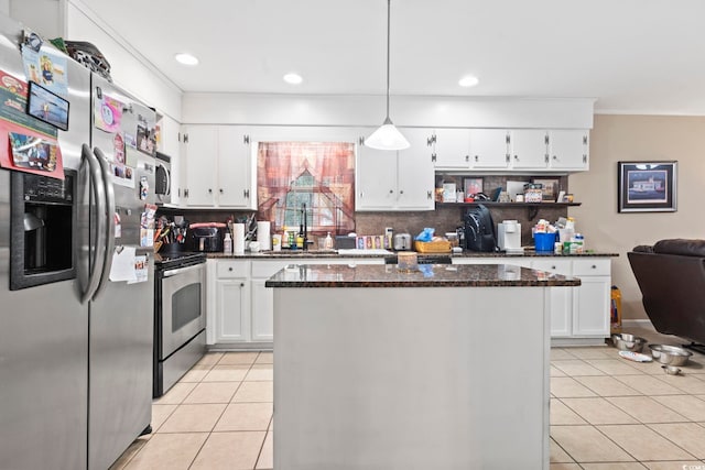 kitchen featuring pendant lighting, sink, light tile patterned floors, appliances with stainless steel finishes, and white cabinetry