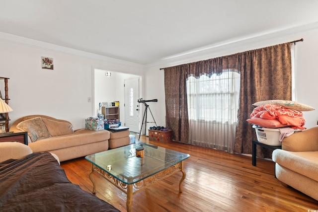 living room with hardwood / wood-style floors and ornamental molding