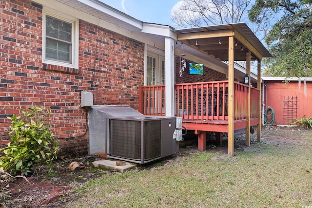 exterior space with a lawn and central AC