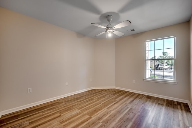 spare room featuring ceiling fan and light wood-type flooring