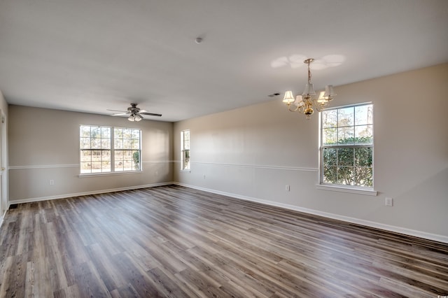 spare room with ceiling fan with notable chandelier and hardwood / wood-style flooring