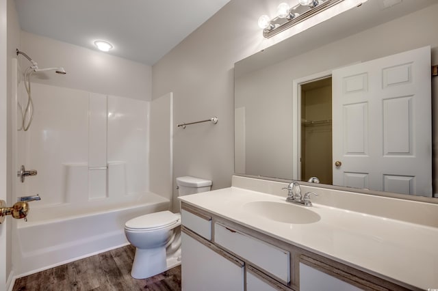 full bathroom featuring hardwood / wood-style floors, vanity, toilet, and shower / tub combination