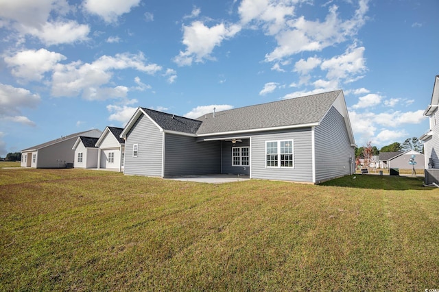 back of property with a lawn and a patio area