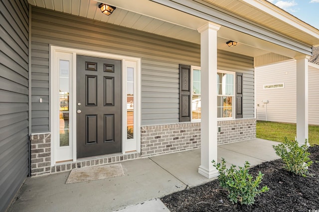 doorway to property featuring covered porch