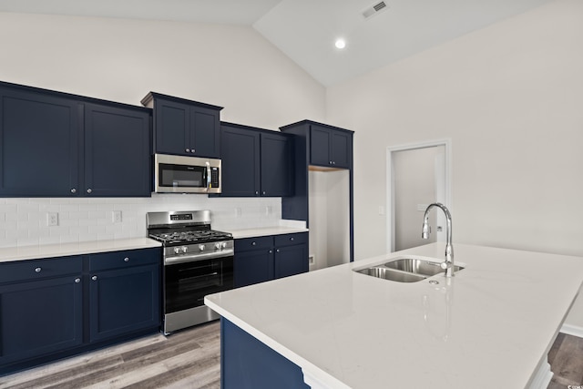 332 Hayloft Cir, Conway, SC 29526 - kitchen with appliances with stainless steel finishes, light wood-style flooring, tasteful backsplash, an island with sink, and light countertops