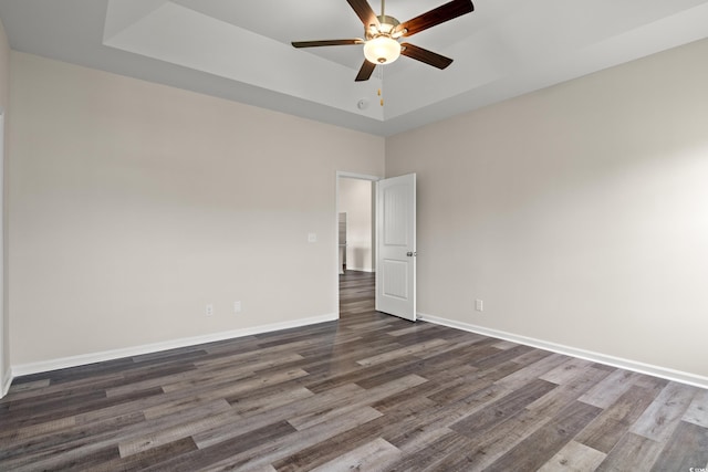 332 Hayloft Cir, Conway, SC 29526 - empty room with a tray ceiling, dark wood finished floors, and a ceiling fan