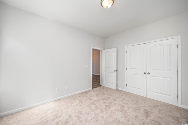 unfurnished bedroom with carpet flooring and a closet