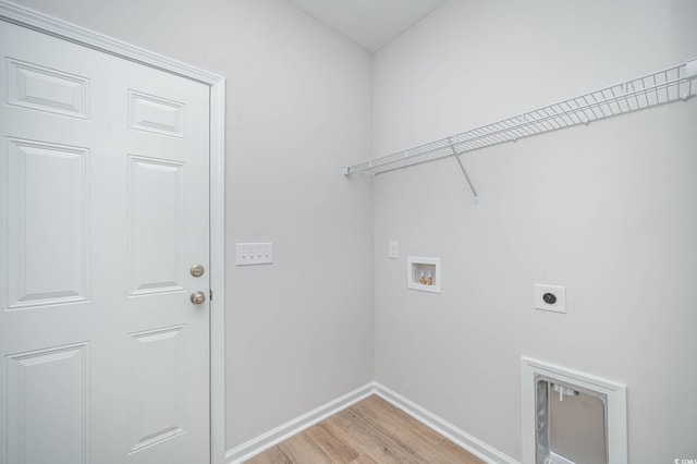 clothes washing area featuring washer hookup, electric dryer hookup, and light hardwood / wood-style floors