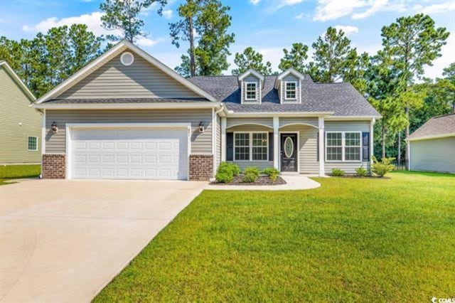 view of front of house with a garage and a front yard