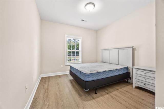 bedroom with hardwood / wood-style flooring