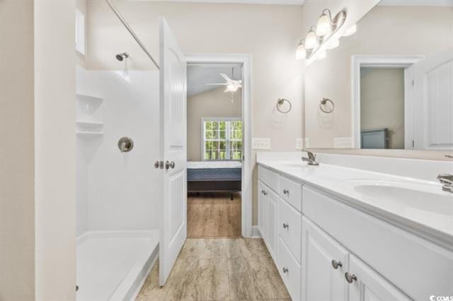 bathroom featuring vanity, hardwood / wood-style flooring, and walk in shower