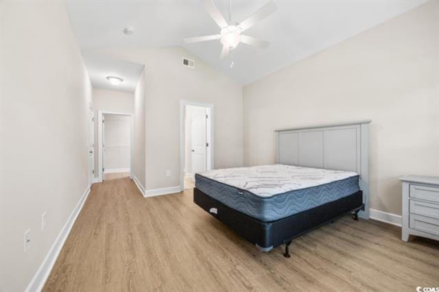 bedroom featuring vaulted ceiling, ceiling fan, and light wood-type flooring