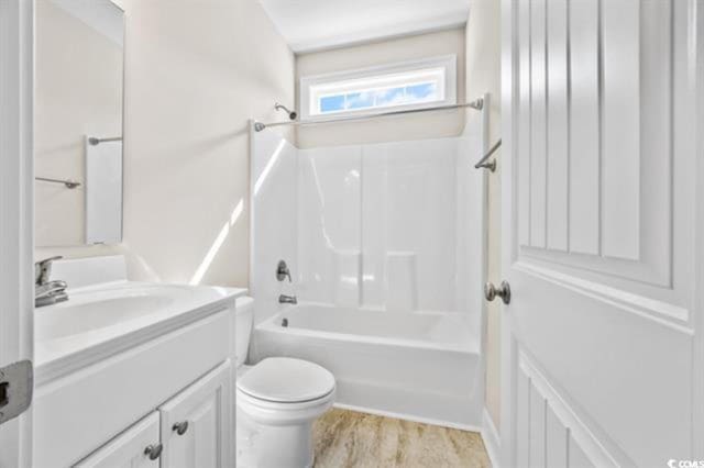 full bathroom featuring vanity, hardwood / wood-style floors, toilet, and shower / bath combination