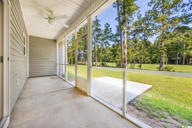 unfurnished sunroom with ceiling fan and a wealth of natural light