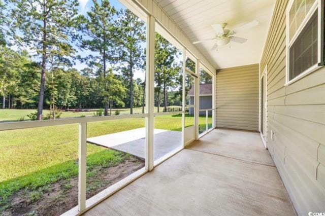 unfurnished sunroom featuring ceiling fan