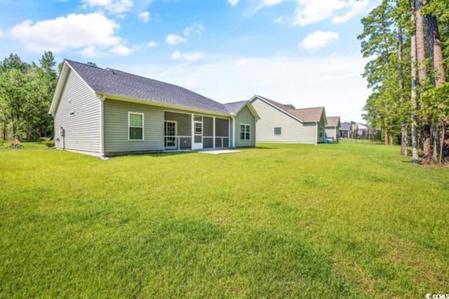 rear view of house with a lawn