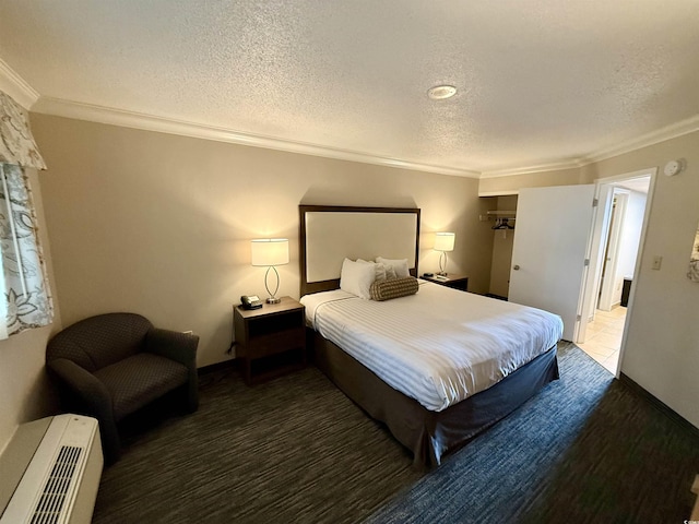 bedroom with a textured ceiling and ornamental molding