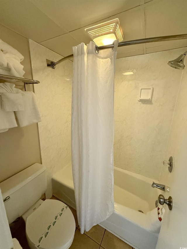 bathroom featuring toilet, tile patterned floors, and shower / bath combo with shower curtain