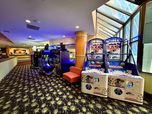 playroom with a skylight and dark carpet