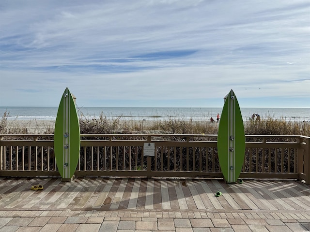 exterior space with a water view and a beach view