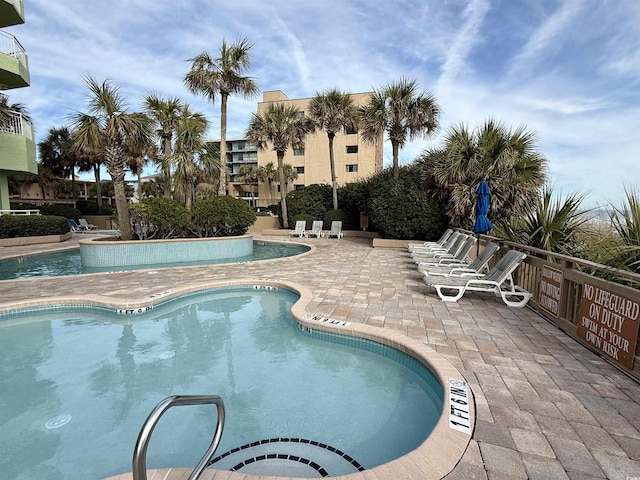 view of swimming pool featuring a patio area