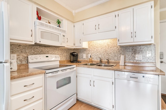 kitchen featuring decorative backsplash, white appliances, white cabinetry, and sink