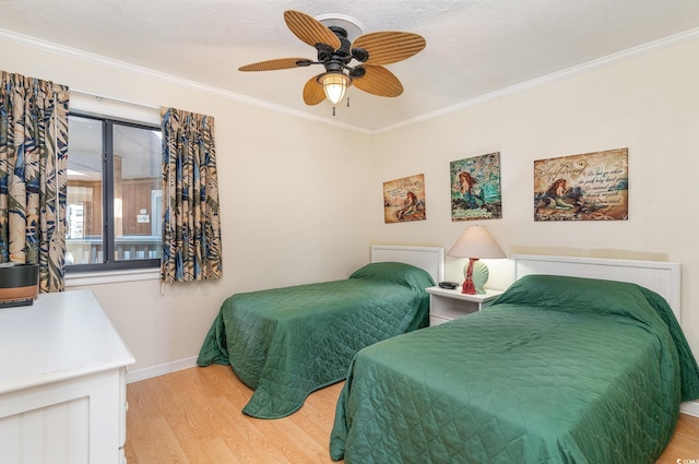 bedroom featuring ceiling fan, light hardwood / wood-style flooring, and ornamental molding